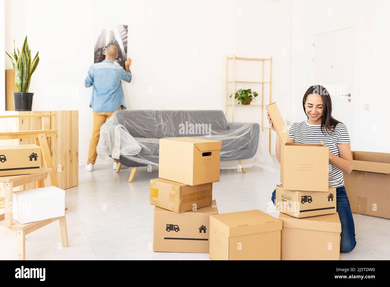 Happy young couple moving to new apartment Stock Photo