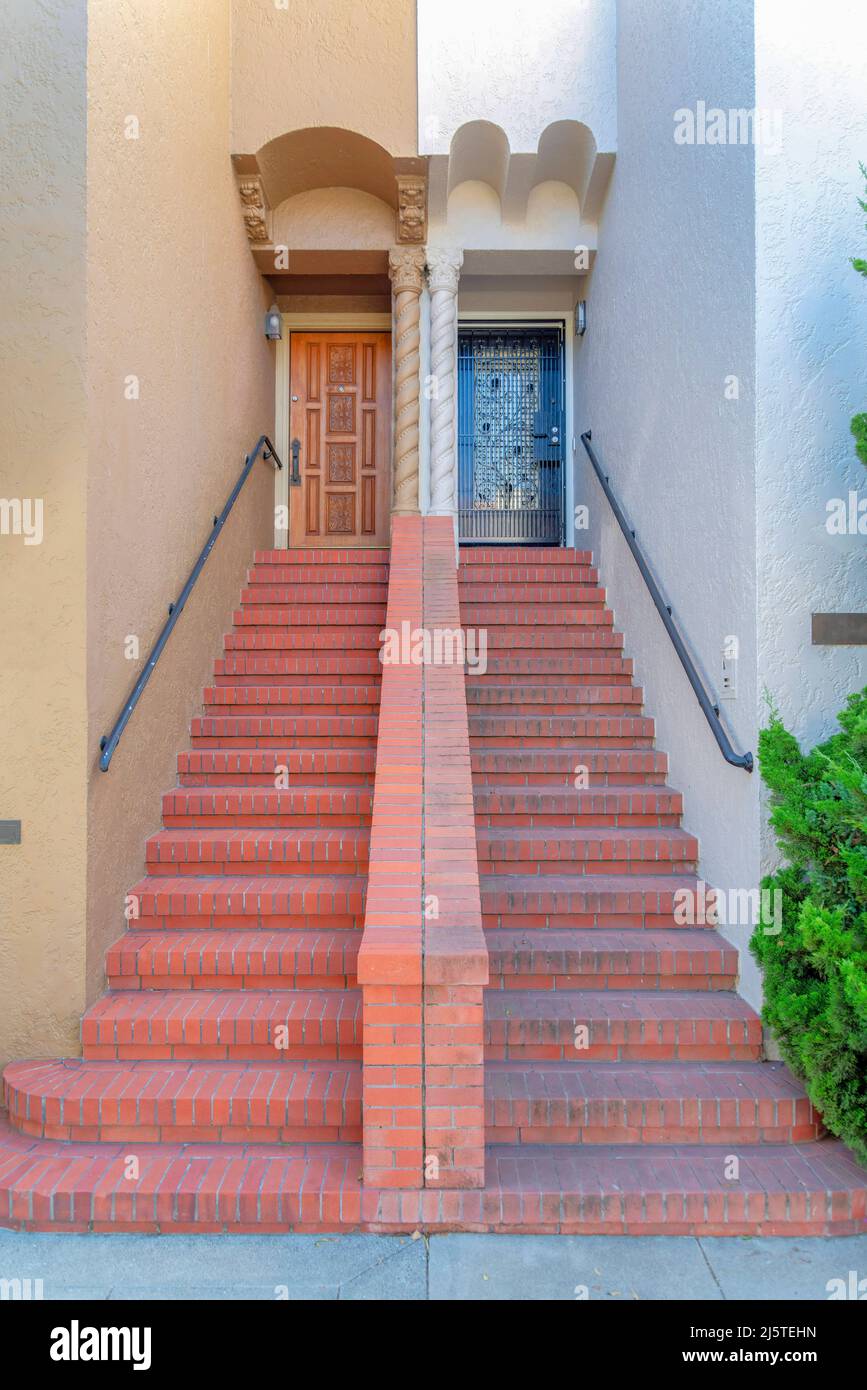 Bricks staircase with half wall divider in the middle and wallmounted