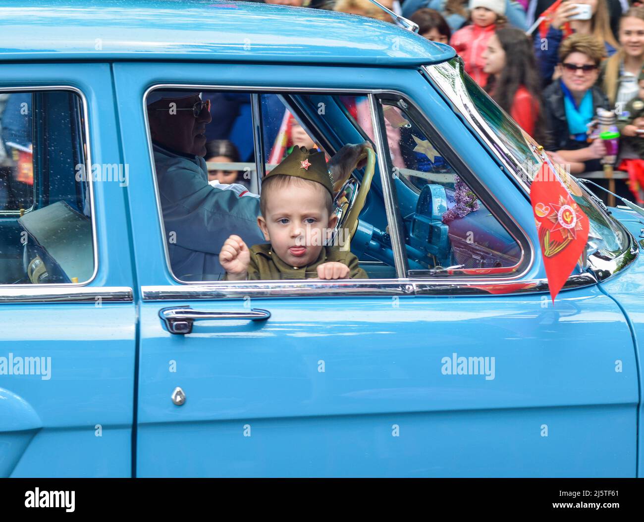 PYATIGORSK, RUSSIA - MAY 09, 2017: A little boy in uniform for the day of victory in a GAZ-21 Volga.Celebration of anniversary of the Victory Day WWII Stock Photo