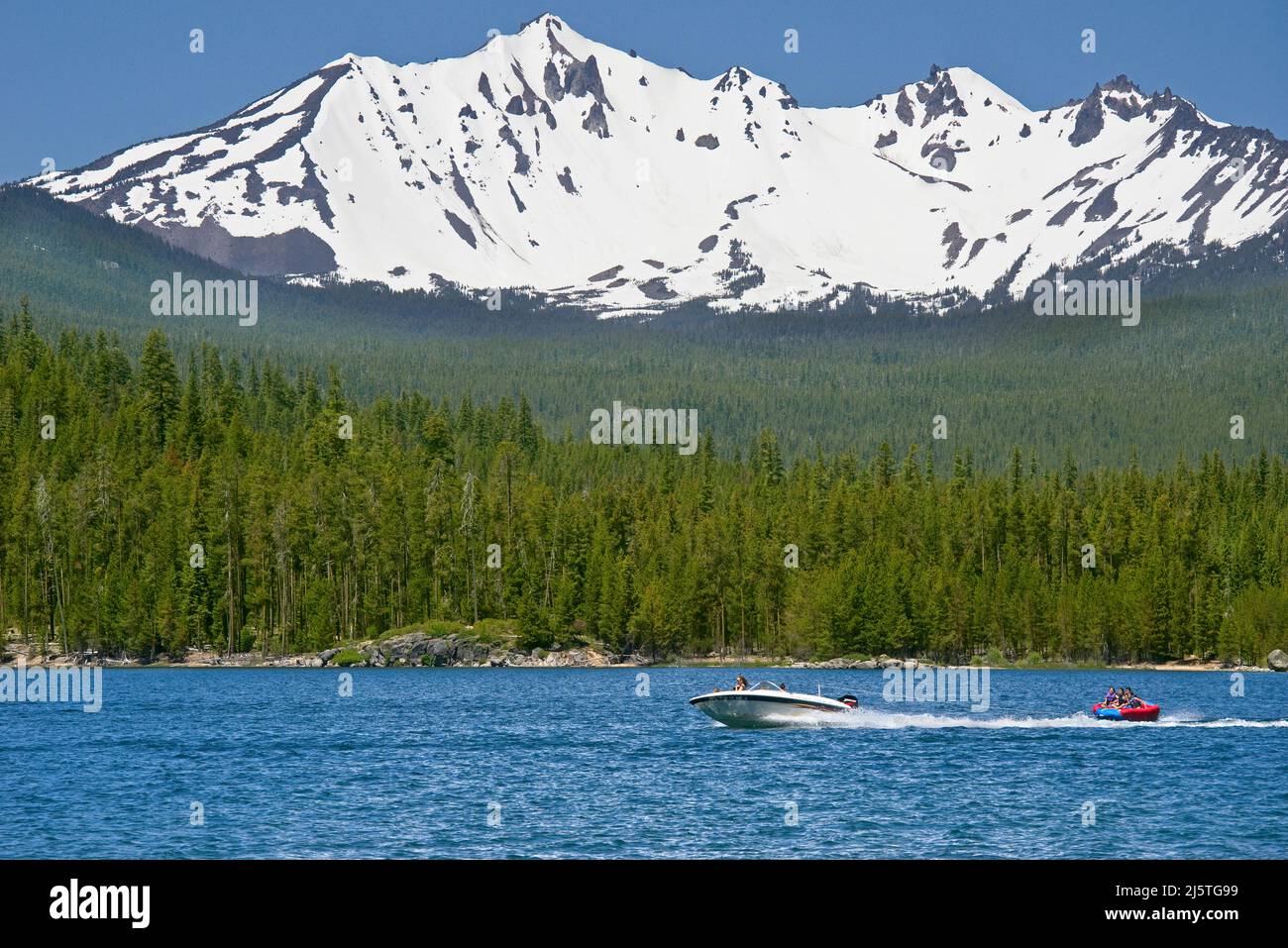 Boating Crescent Lake below Diamond Peak Wilderness, Cascade Range