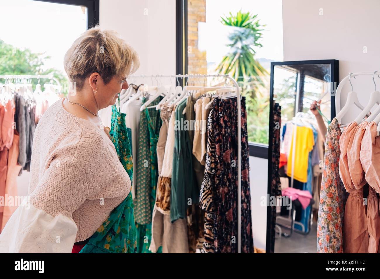 mature woman enjoying a shopping day. blonde woman shopping in a fashion shop. concept of shopping. Stock Photo