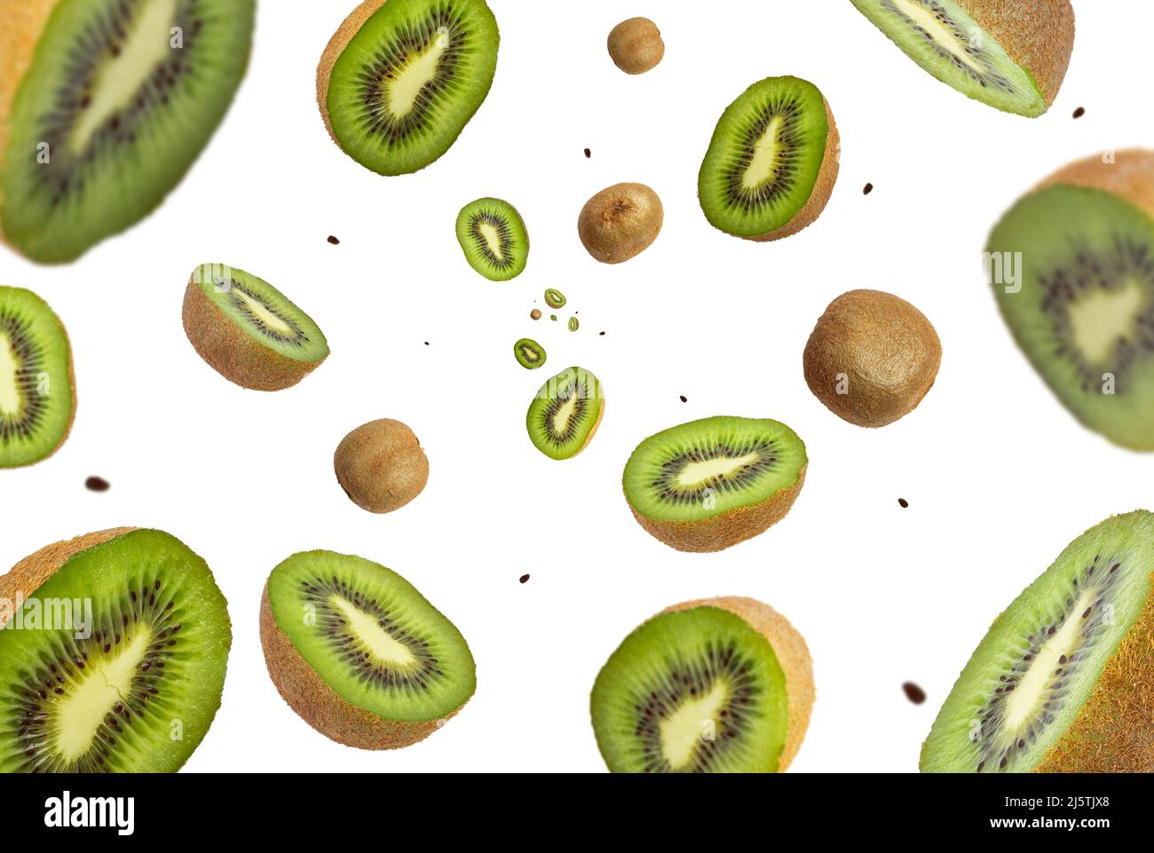 Collection of fresh real Kiwi fruit falling isolated on white background. Selective focus Stock Photo