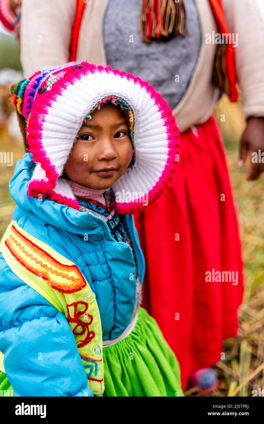 An Uros Child On The Uros Floating Islands, Lake Titicaca, Puno, Peru. Stock Photo