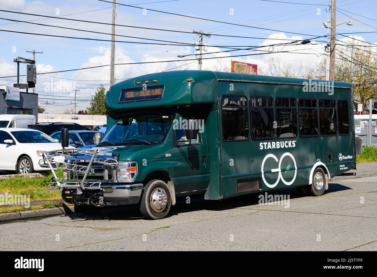 Seattle - April 22, 2022; TransWest shuttle bus in Starbucks Go livery parked near the coffee company headquarters in Seattle Stock Photo