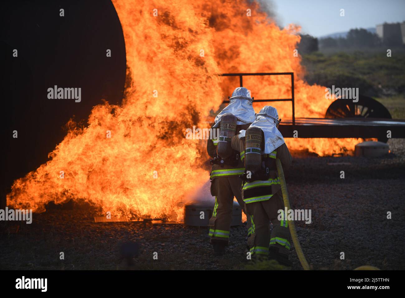 A team of firefighters put out a fire around a training aircraft during the joint firefighter integrated readiness ensemble training exercise on Vandenberg Space Force Base, Calif., April 7, 2022. The Vandenberg Fire Department trains on JFIRE annually to retain their certification. (U.S. Space Force photo by Airman 1st Class Ryan Quijas) Stock Photo