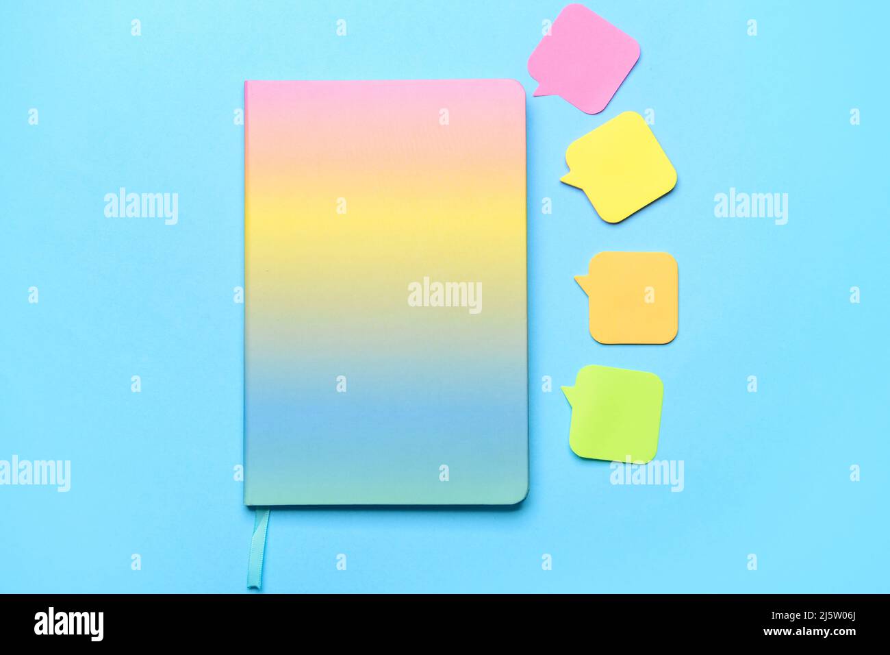 Notebook and sticky note papers on color background Stock Photo