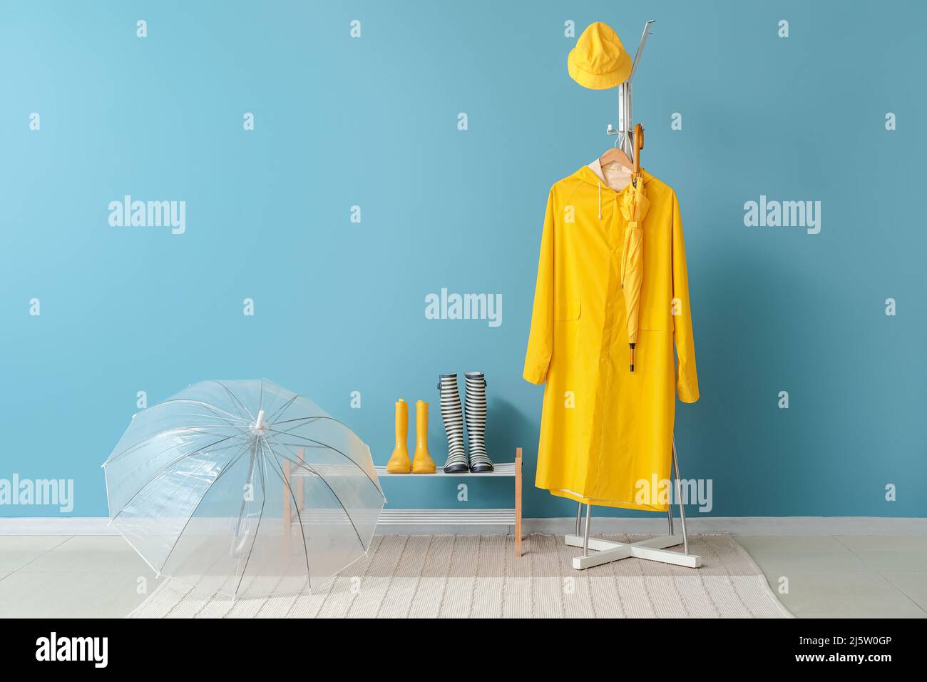 Raincoat, gumboots and umbrella in hallway Stock Photo Alamy