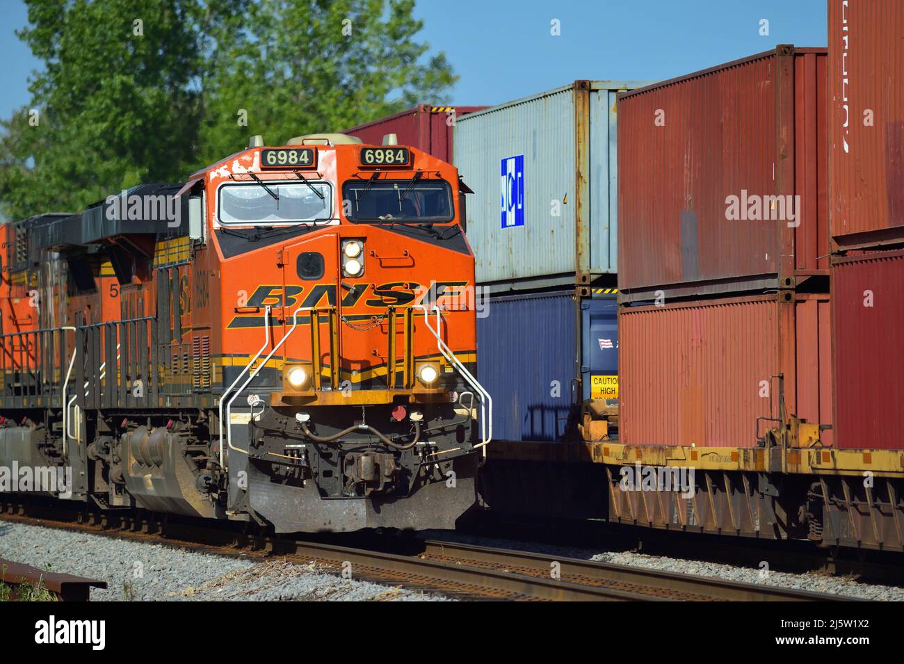 Hoffman Estates, Illinois, USA. A Canadian National Railway freight train led by an off-road, run-through Burlington Northern Santa Fe locomotives. Stock Photo