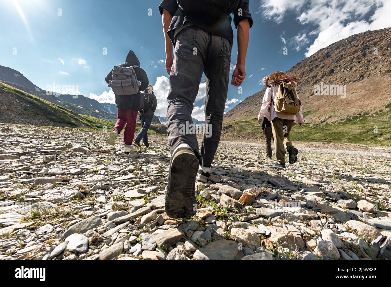 Group of walking hikers in mountains. Travel concept Stock Photo