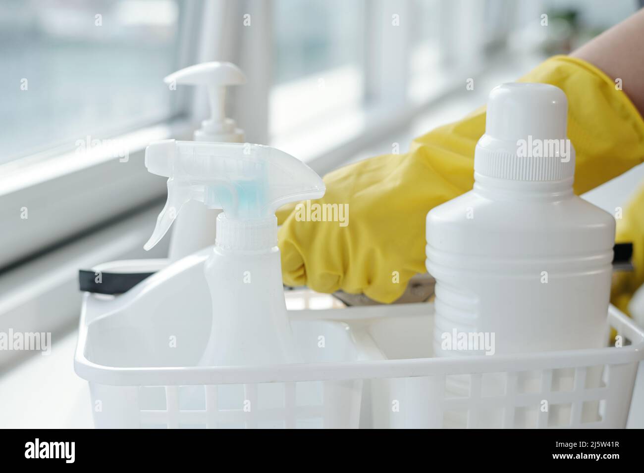 Group of white plastic bottles with detergents for washing windows in