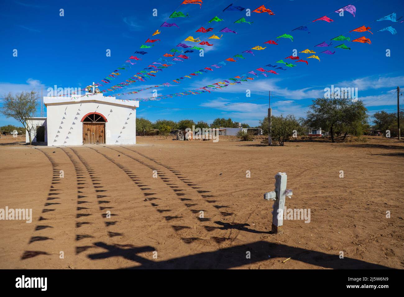 Church and colored papel picado flags typical of the Day of the Dead or  typical Mexican decoration in the Paredón Colorado or Paredón Viejo is a  ranchería in the municipality of Benito