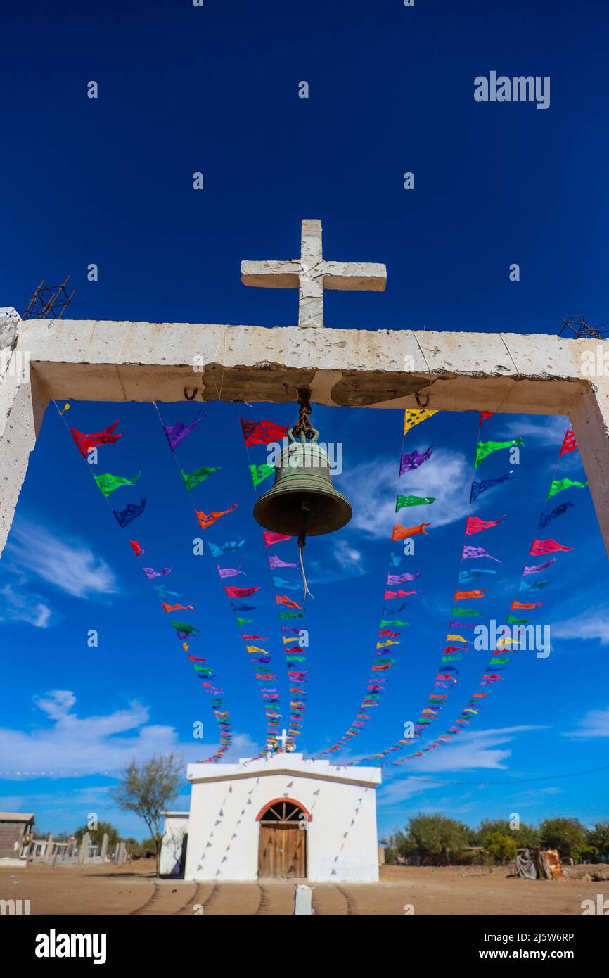 Church and colored papel picado flags typical of the Day of the Dead or  typical Mexican decoration in the Paredón Colorado or Paredón Viejo is a  ranchería in the municipality of Benito