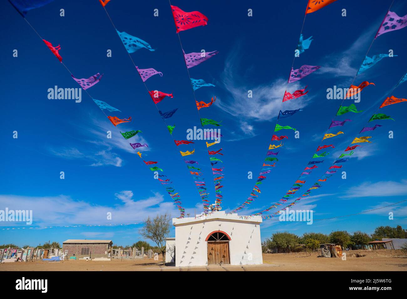 Church and colored papel picado flags typical of the Day of the Dead or  typical Mexican decoration in the Paredón Colorado or Paredón Viejo is a  ranchería in the municipality of Benito