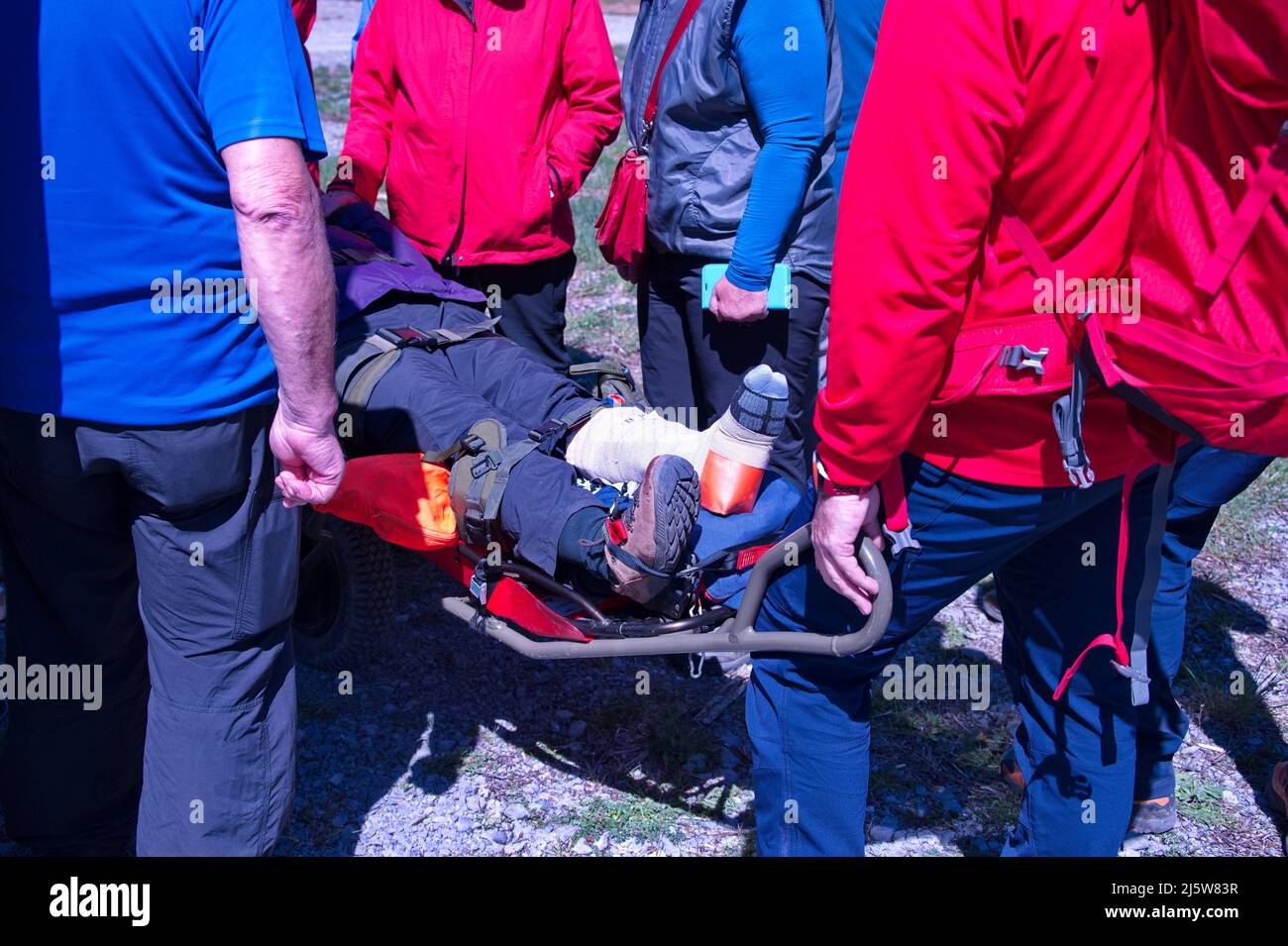 Paramedics from mountain rescue service provide first aid to person