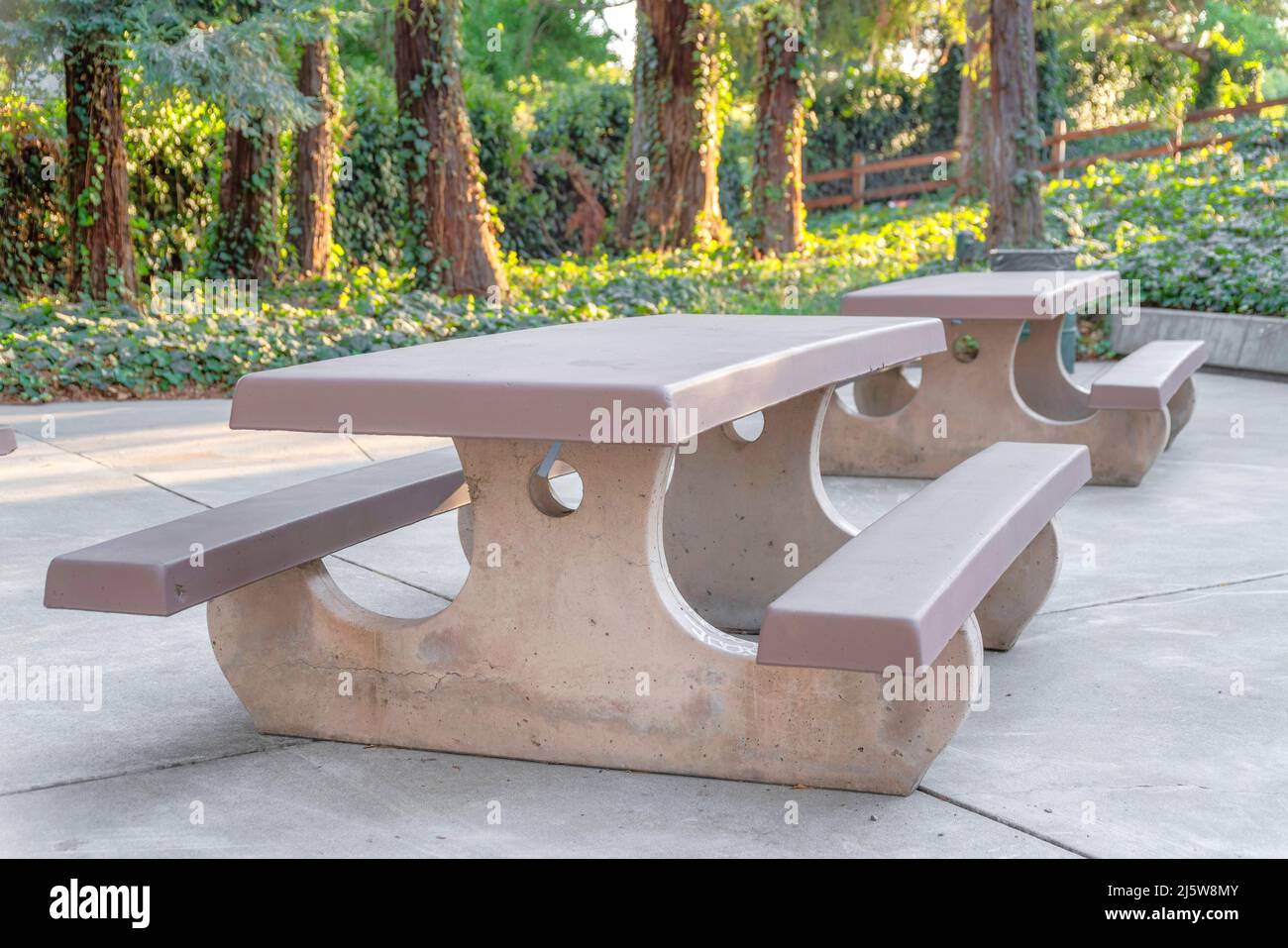 Picnic table with two seats on a concrete pavement at Japanese Friends
