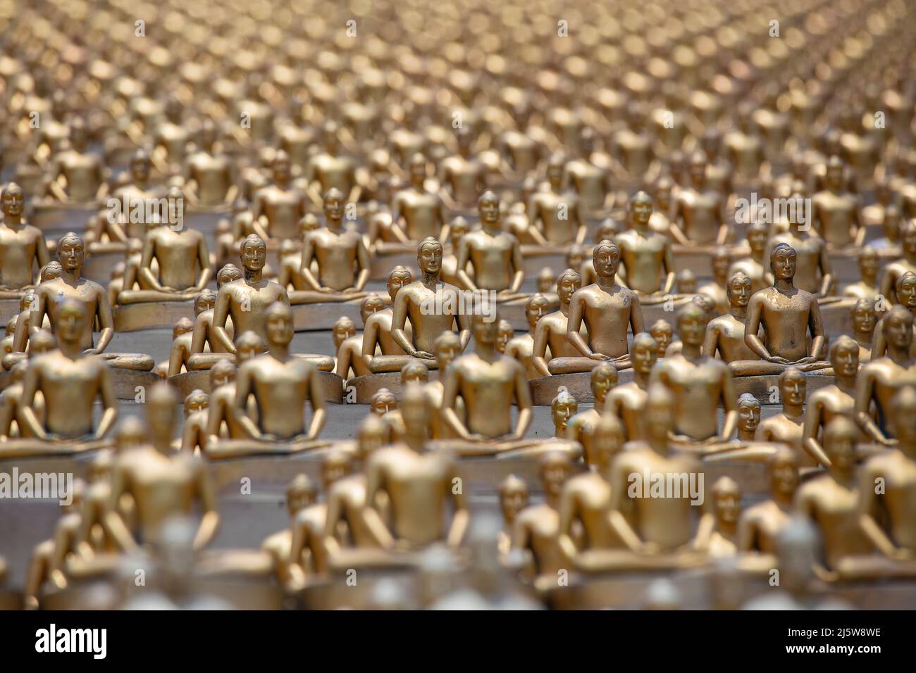 Million golden Buddha figurine in Wat Phra Dhammakaya. Buddhist temple in Bangkok, Thailand. Close up Stock Photo