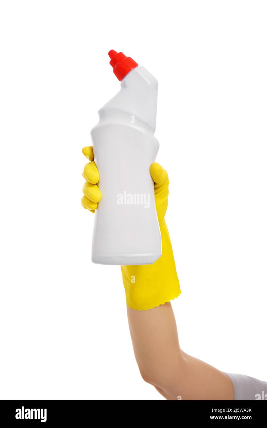 hand in yellow rubber glove holding plastic bottle with toilet cleaner ...