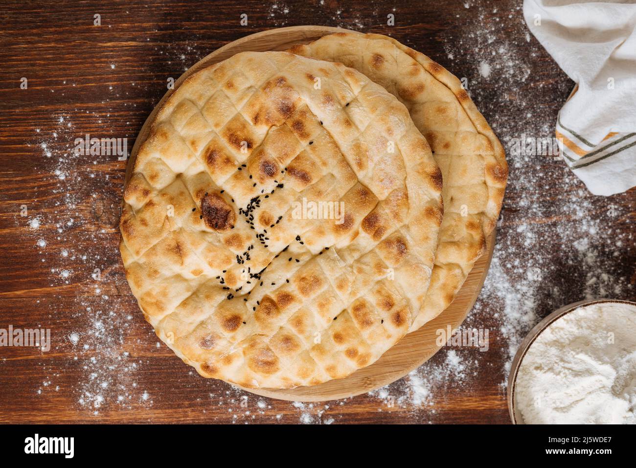Top view of traditional Turkey or Bosnian pita bread called Somun or Lepina. Popular bread to eat during the month of Ramadan or Eid Mubarak. Rustic w Stock Photo