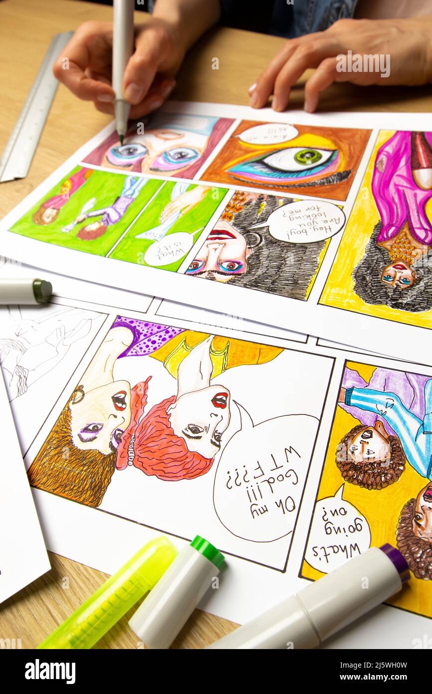 The artist designer draws sketches of comic book characters on paper. The animator creates a storyboard on paper. Stock Photo