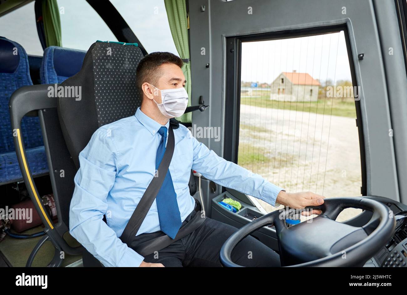 bus driver in mask talking to microphone Stock Photo