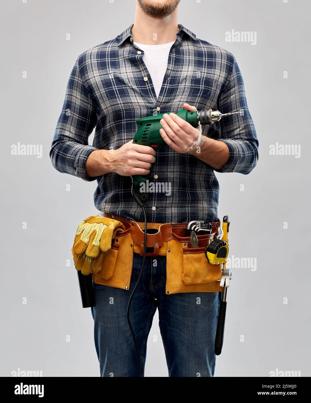 male repairer or builder with drill and work tools Stock Photo