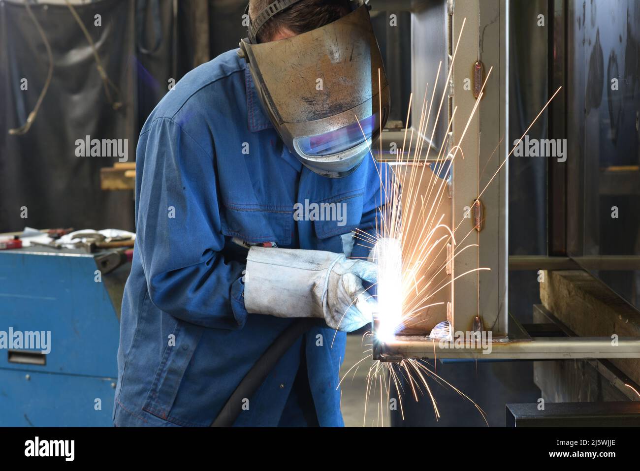 welder at work in a steel construction company - working and protective clothing Stock Photo