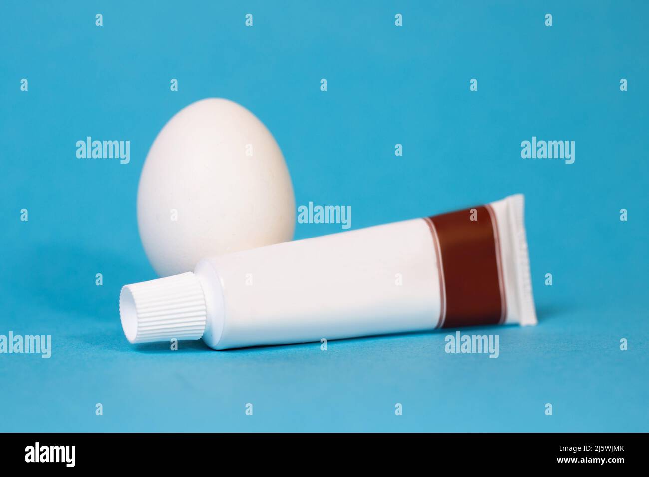 egg and a tube of toothpaste on a blue background Stock Photo Alamy