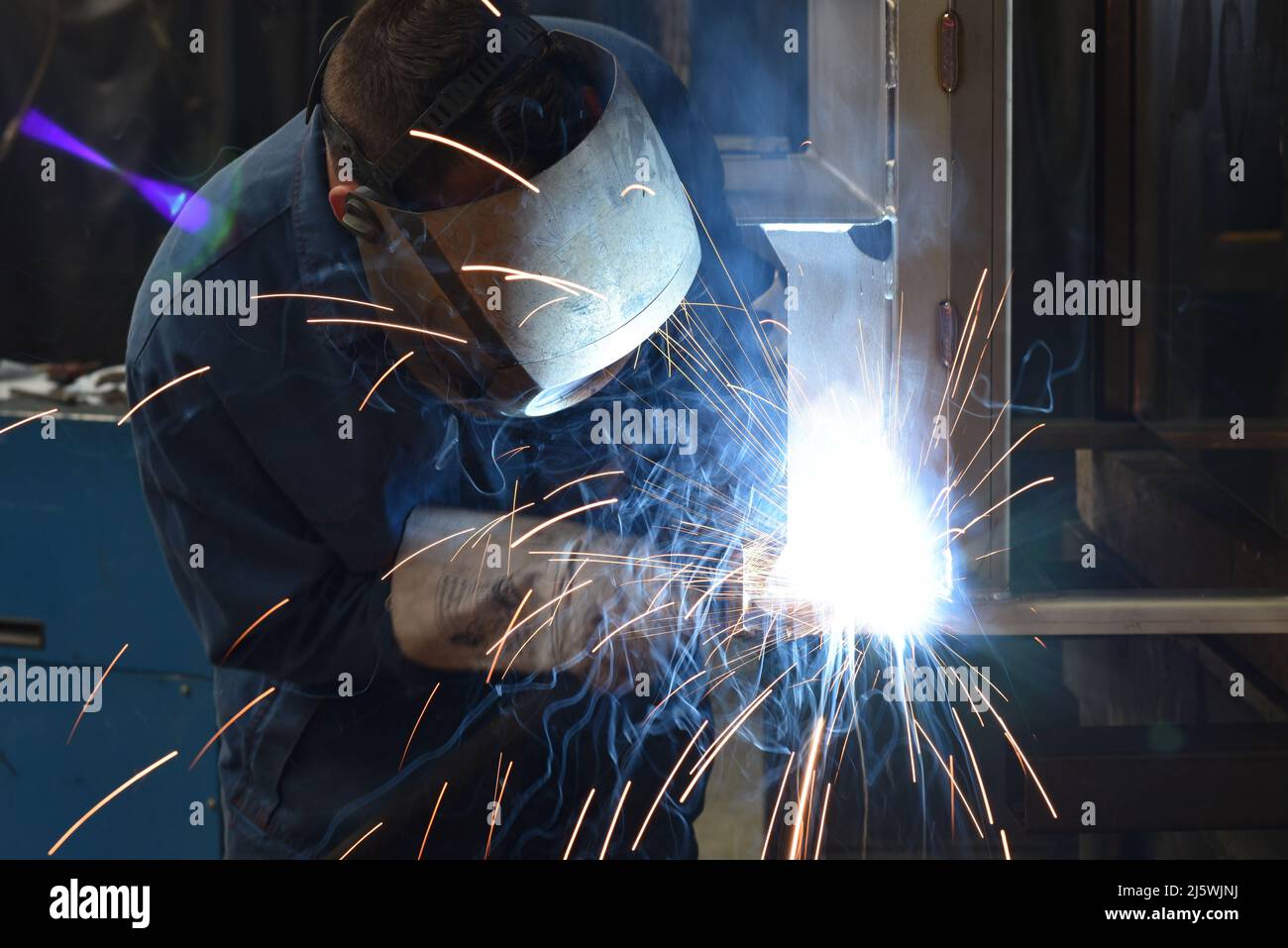 welder at work in a steel construction company - working and protective clothing Stock Photo