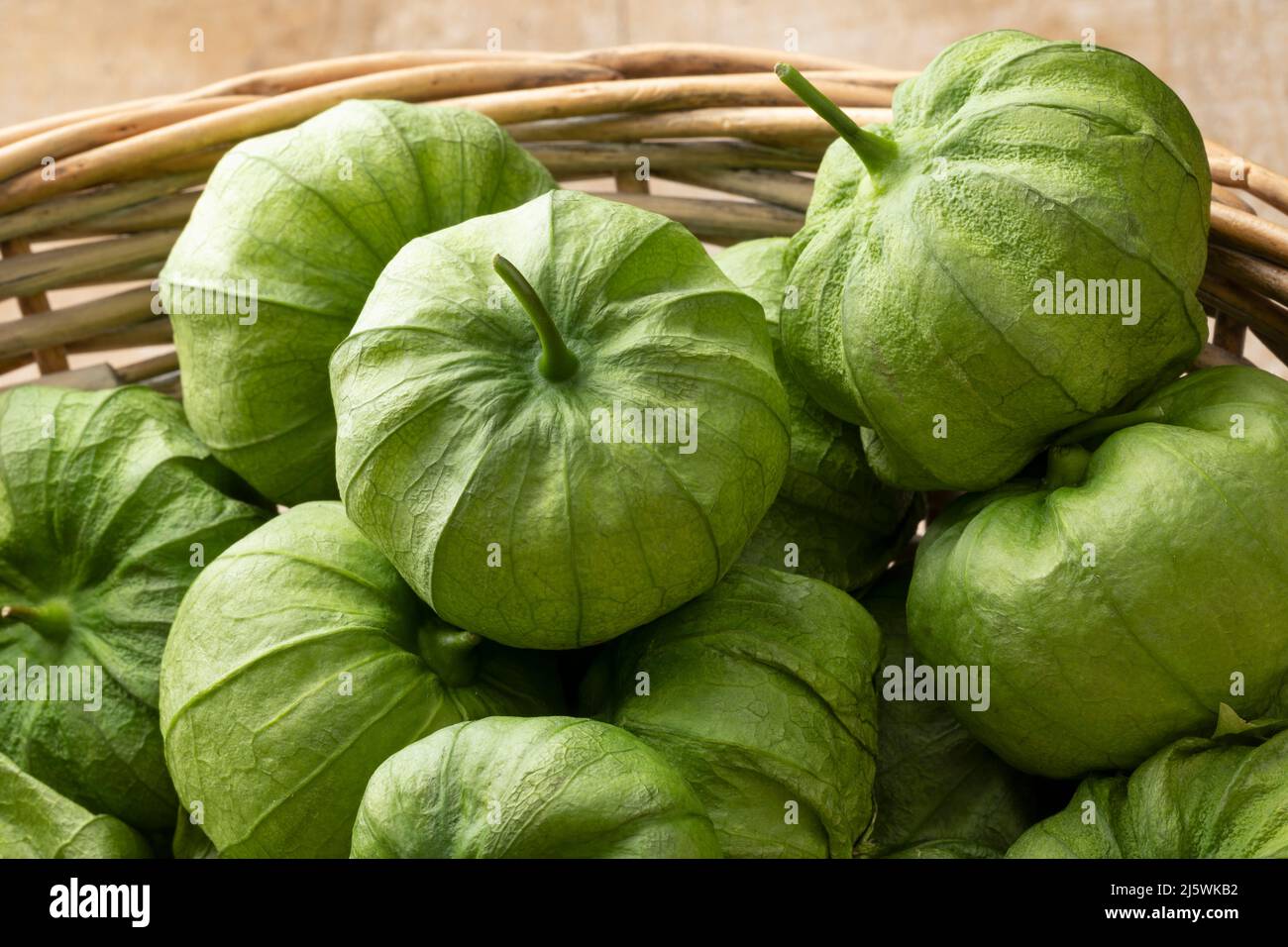 Basket with fresh green Mexican tomatillo in a husk close up Stock Photo