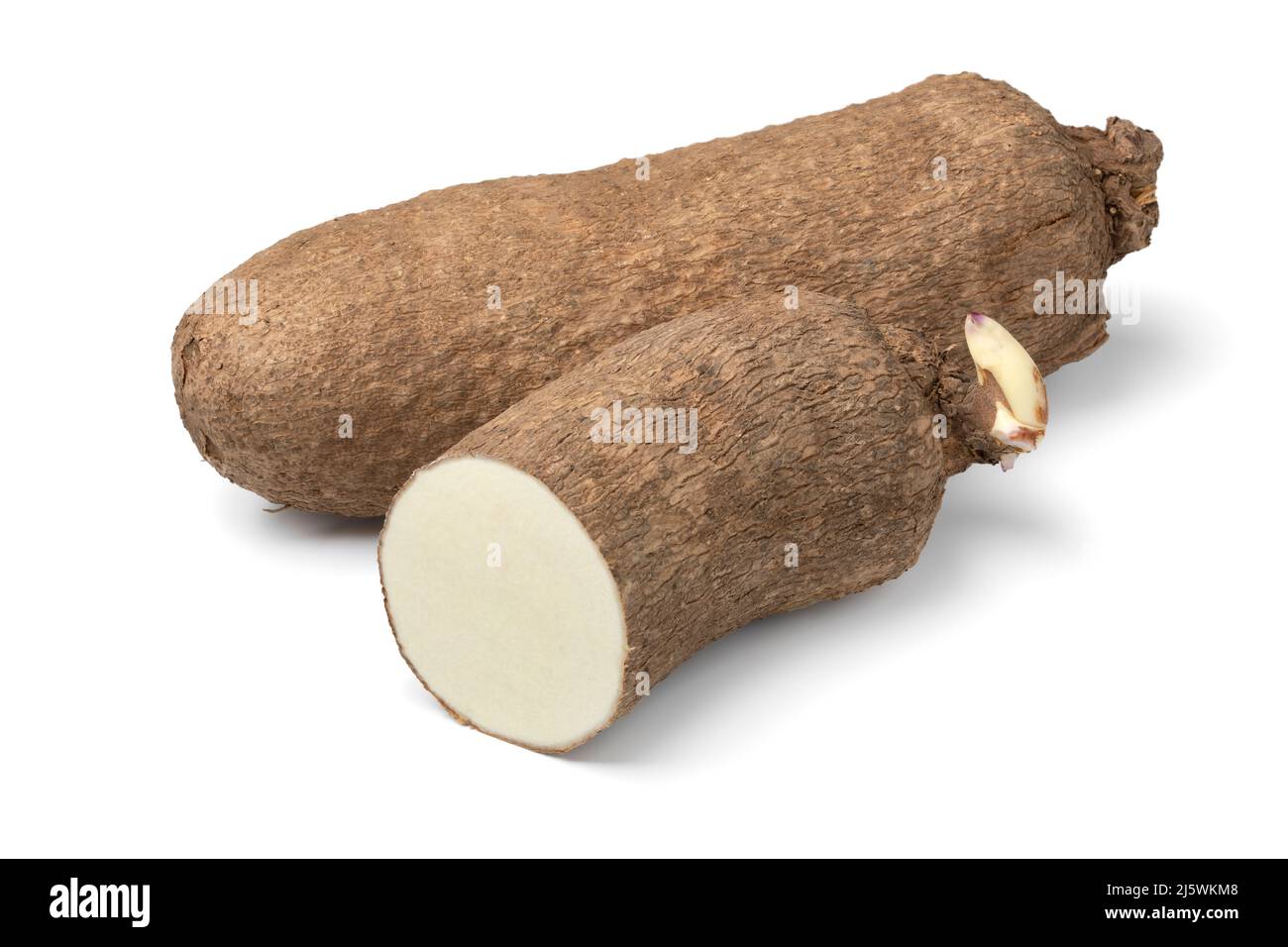 Whole and halved raw African yam isolated on white background Stock Photo