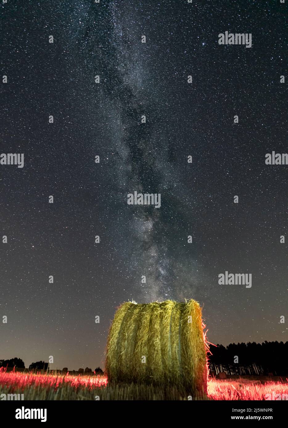 Straw ball under the milky way with red light Stock Photo - Alamy