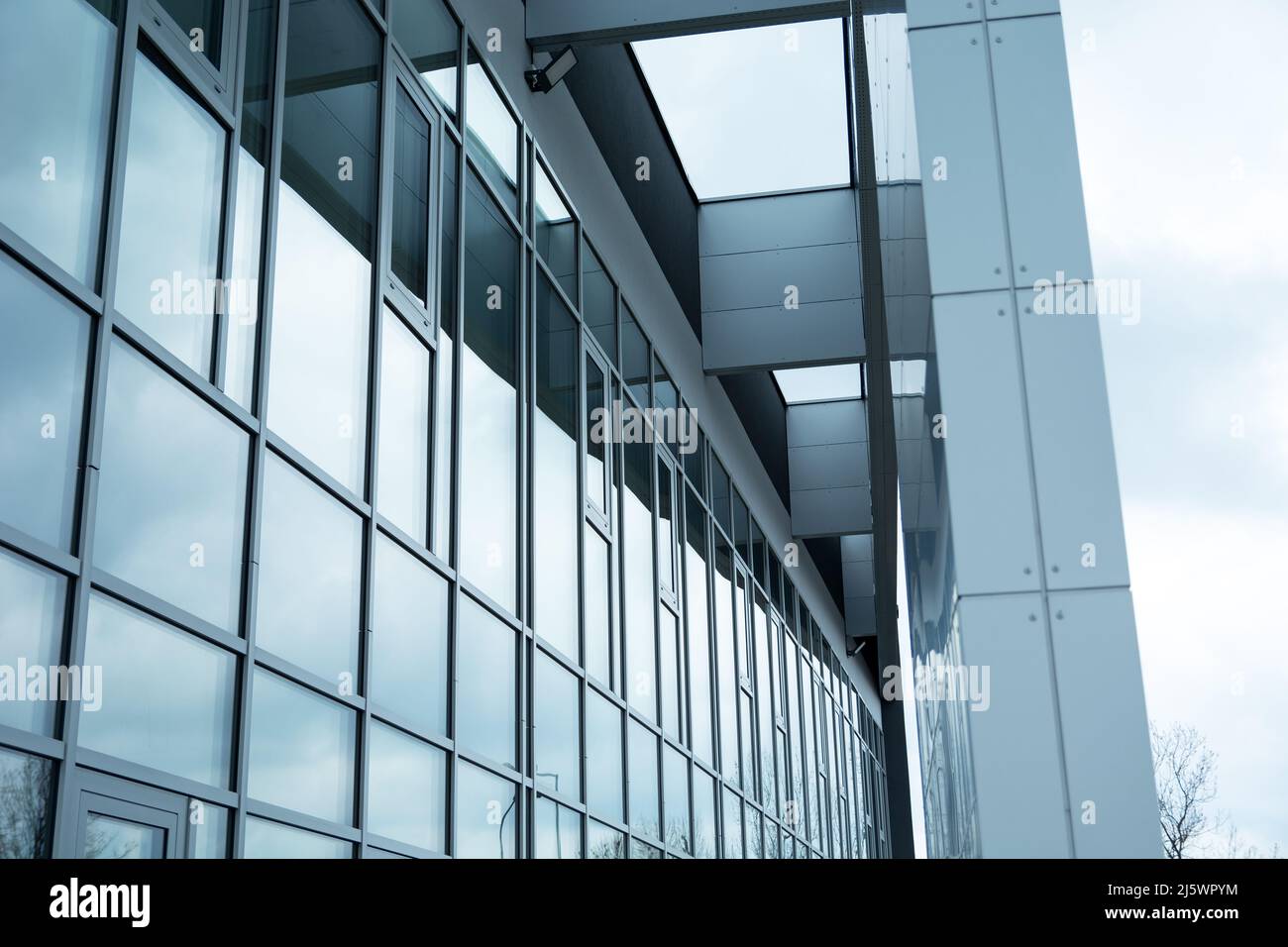 Modern office building with glass facade and metal construction elements Stock Photo