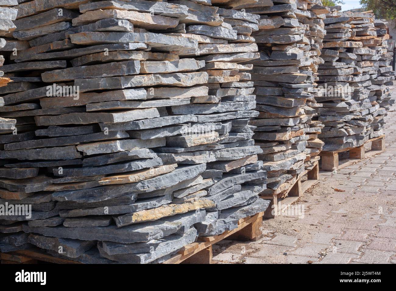 Pallets with natural stone close up. Folded flagstone. Horizontal photo