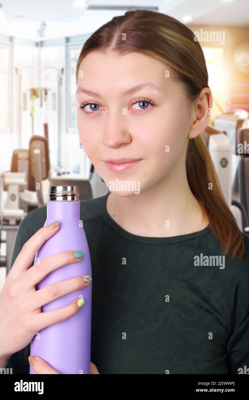 young fit girl with mineral water after training Stock Photo