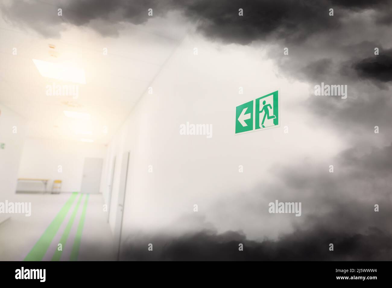 Emergency exit and smoke in office building Stock Photo