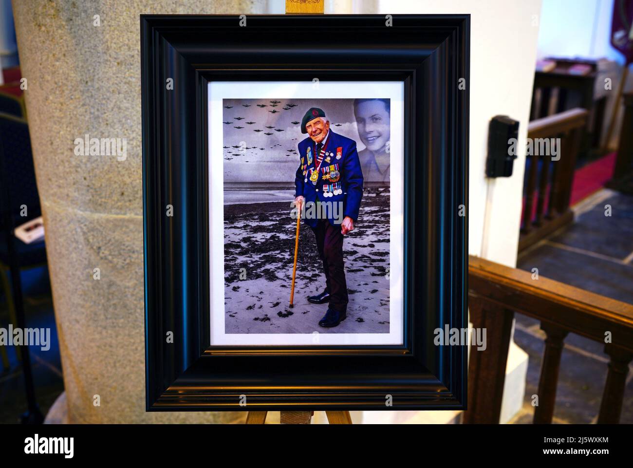 A framed photograph of Harry Billinge in the church for the funeral of the 96-year-old World War II serviceman and Royal British Legion fundraiser, at St Paul's Church in Charlestown, Cornwall. Harry was just 18 when he was one of the first British soldiers to land on Gold Beach during the Battle for Normandy and was one of only four survivors from his unit. Picture date: Tuesday April 26, 2022. Stock Photo
