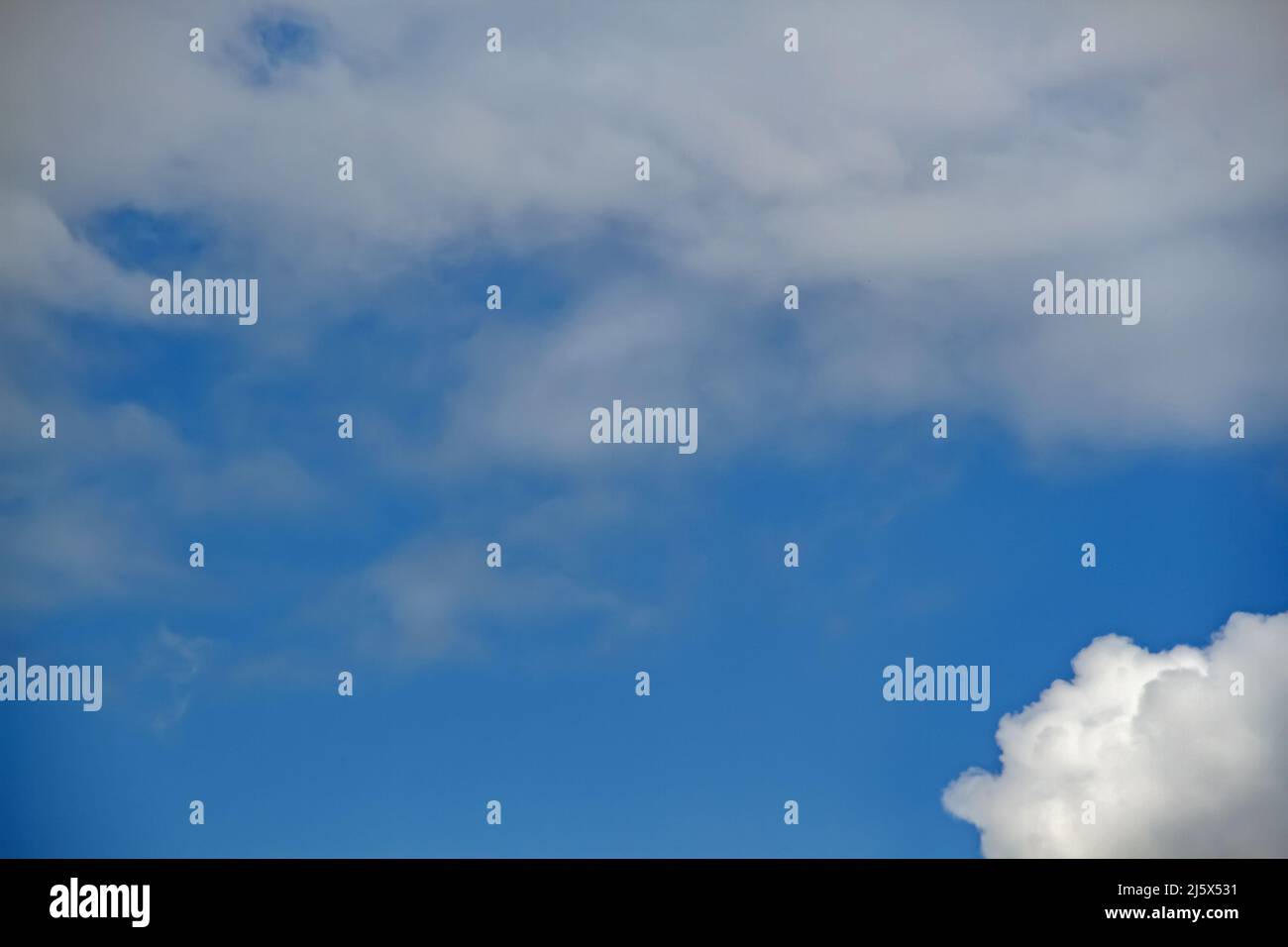 Blue sky with white fluffy clouds used as a background or texture Stock ...
