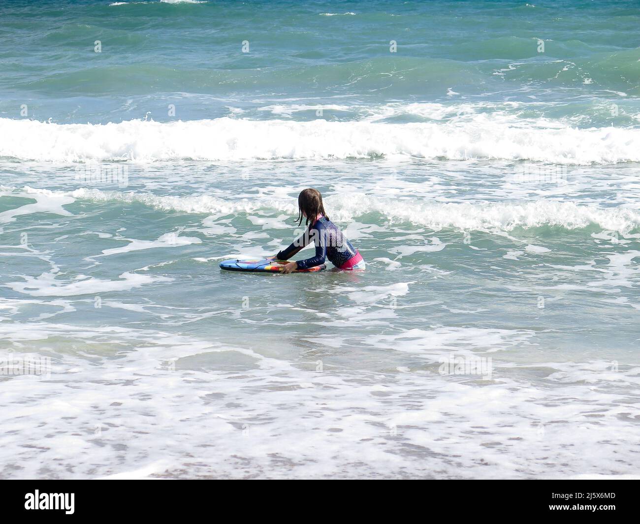 Kids playing in the surf with boogie boards at west Palm Beach, Florida
