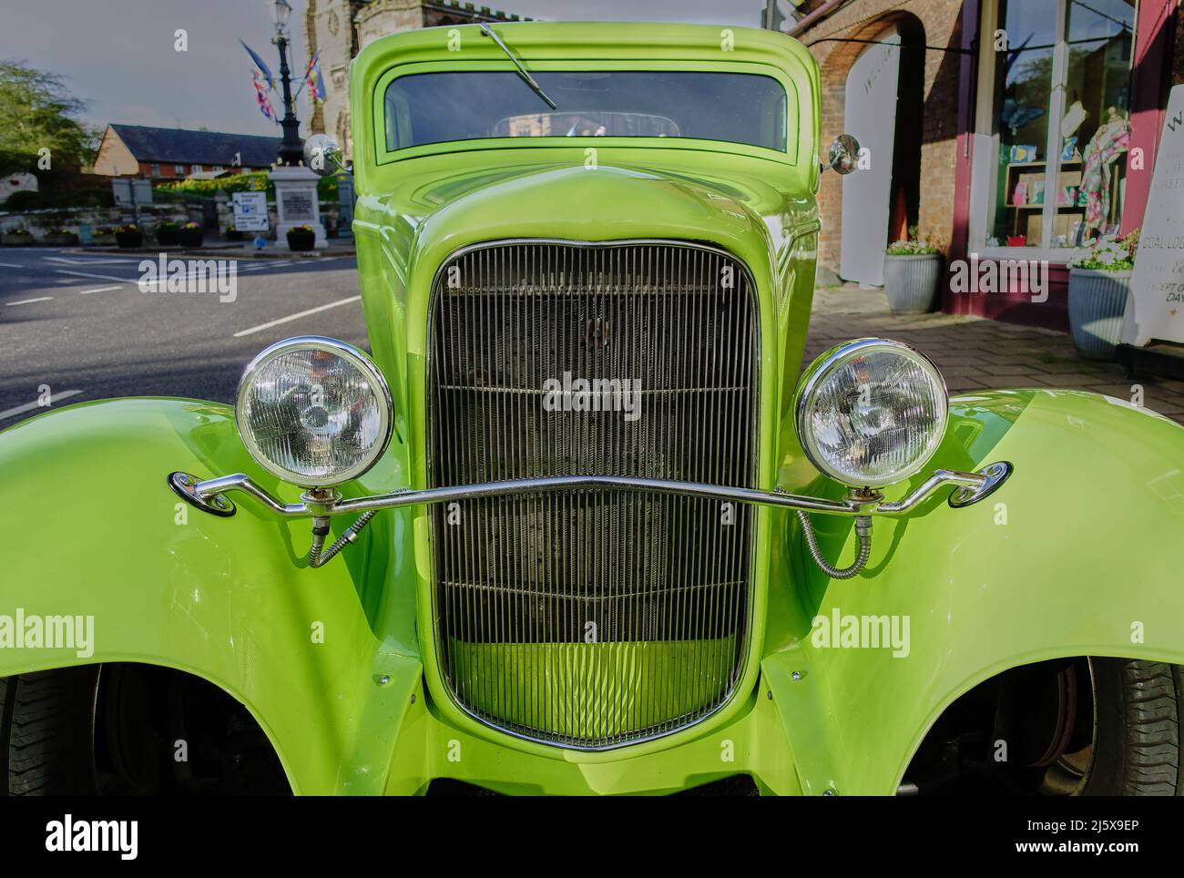 View of a vivid green American style hot rod showing the grille and headlights Stock Photo