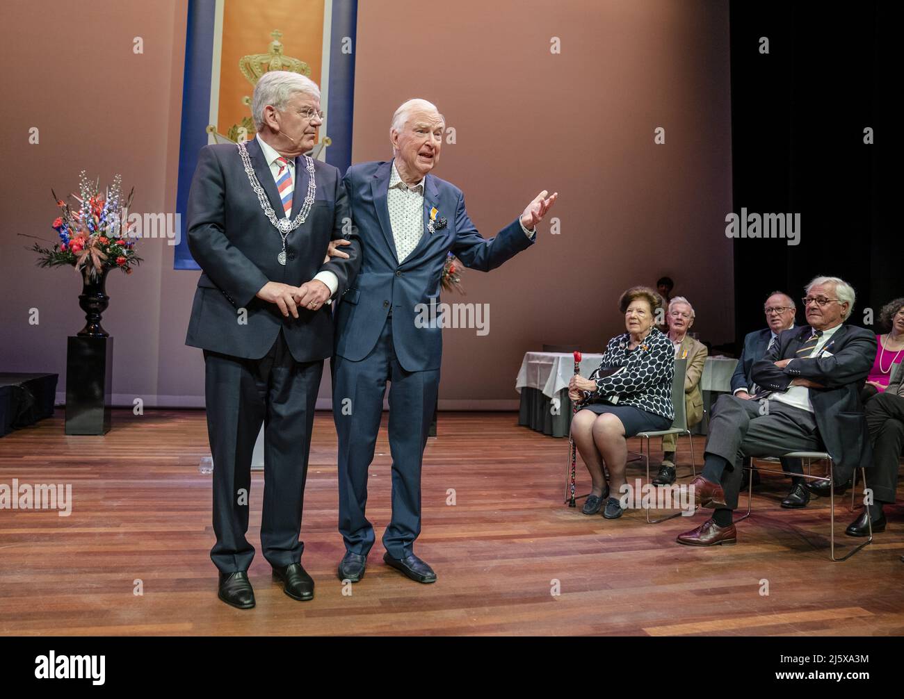 THE HAGUE - the Netherlands, 2022-04-26 12:25:53 THE HAGUE - Former  journalist and theater producer Henk van der Meijden receives a royal award  from mayor Jan van Zanen during the annual ribbon