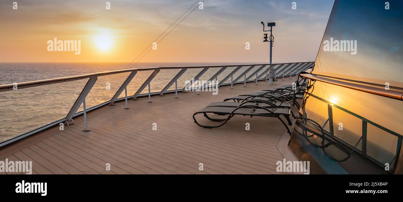 Cruise ship deck at sunset. Reflection of the sun in the window Stock ...
