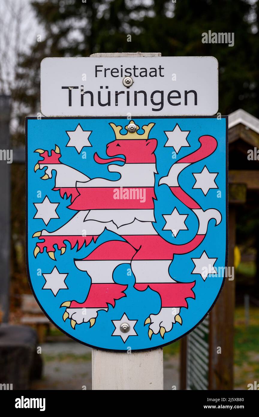 Tettau, Germany. 25th Apr, 2022. Sign with coat of arms of the Free State of Thuringia. Border between the states of Bavaria and Thuringia at the Frankenwaldhütte. Credit: Daniel Vogl/dpa/Alamy Live News Stock Photo