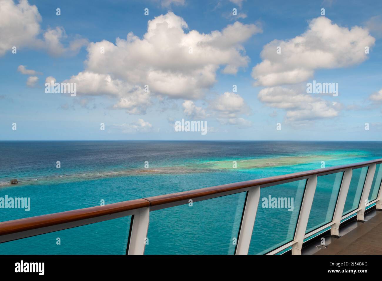 Cruise ship railing with a view of the beautiful sea in Aruba. Stock Photo
