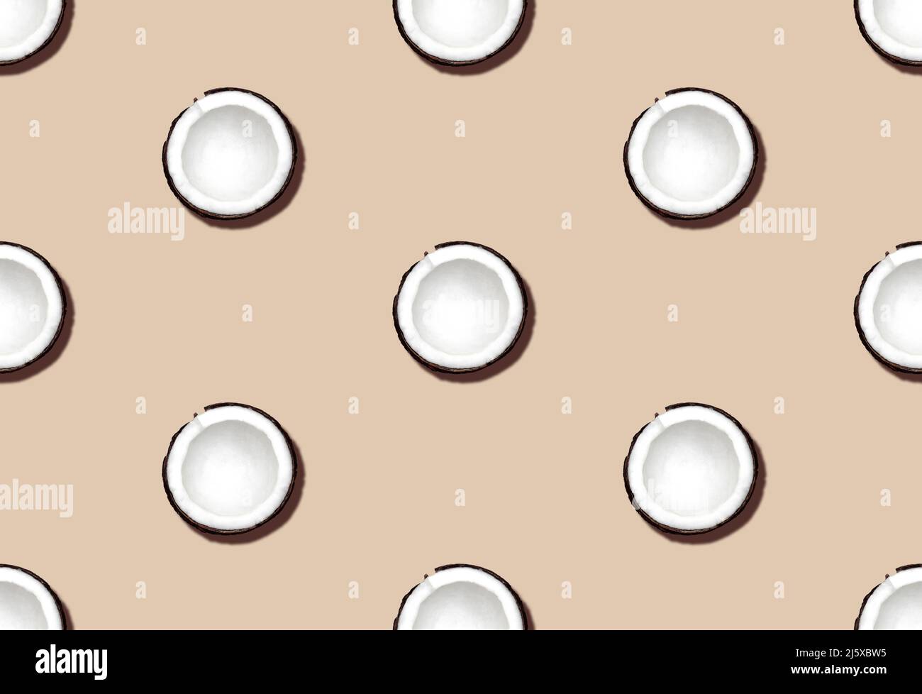 Fresh cut coconuts on beige background. Top view. Stock Photo