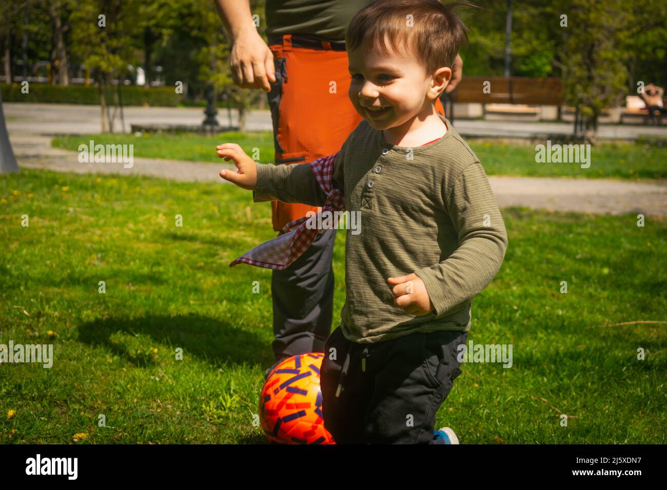 Father and son playing football in park outdoor family activities football fans supporters warming for Qatar World Cup 2022 father and son playing ama Stock Photo