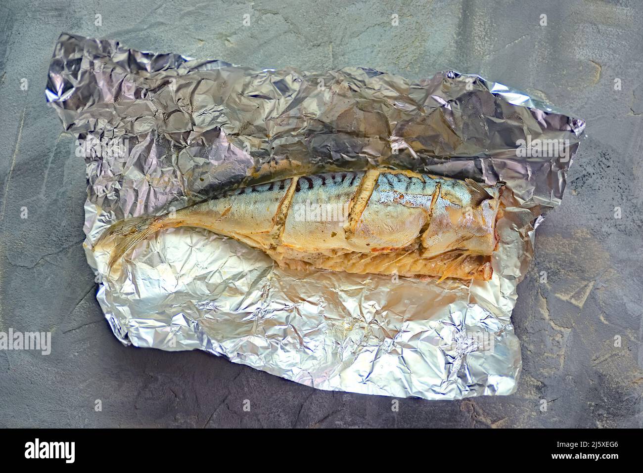 baked mackerel fish with lemon in foil Stock Photo Alamy