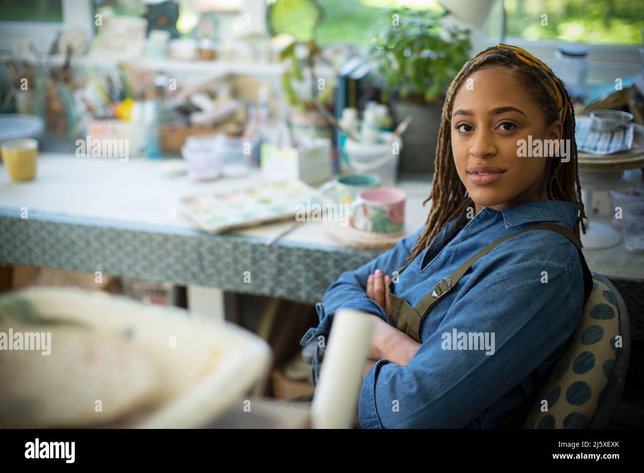 Portrait confident young female artist in art studio Stock Photo - Alamy