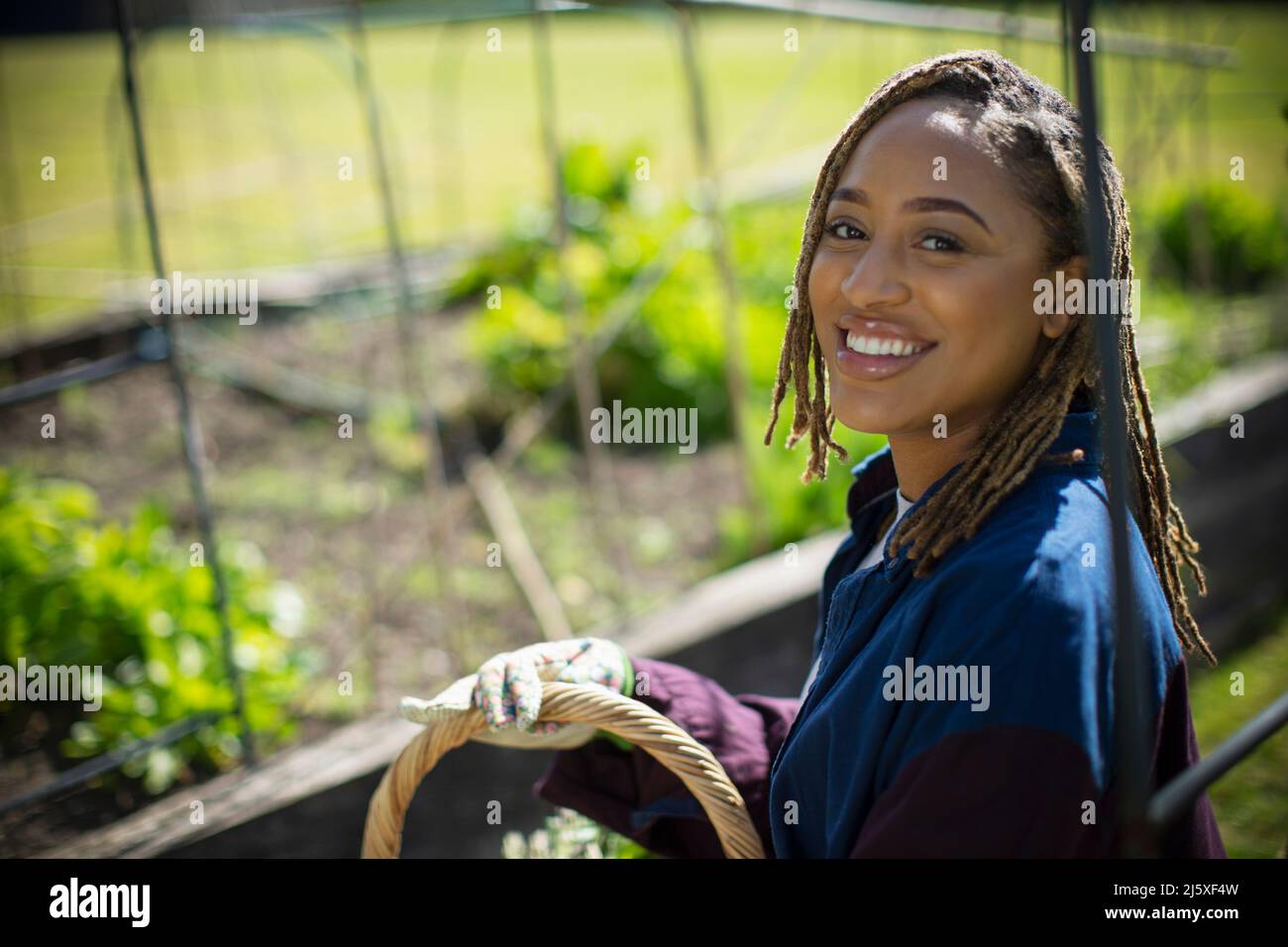 Portrait happy young woman gardening Stock Photo