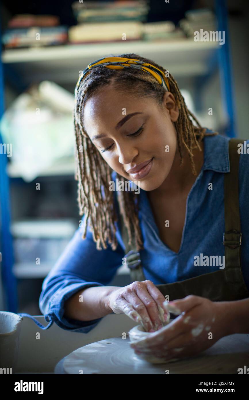 Young woman at pottery wheel Stock Photo
