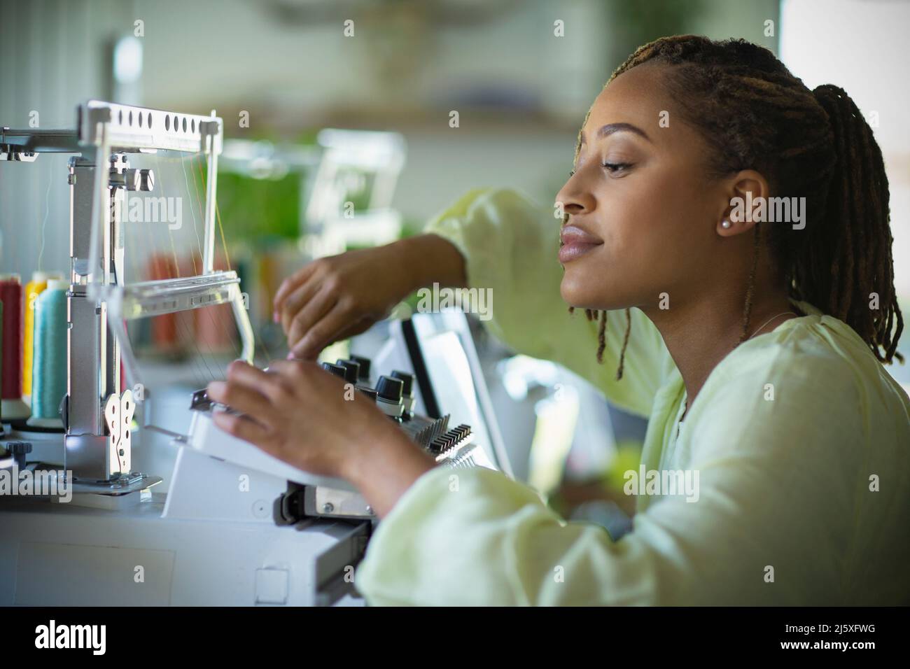 Young female seamstress at sewing machine Stock Photo
